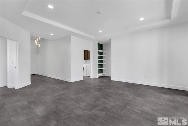 empty room featuring washer and clothes dryer, recessed lighting, dark wood finished floors, and baseboards