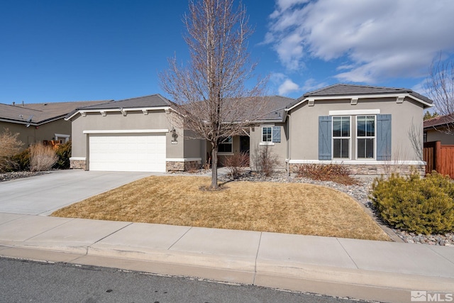 view of front facade with stone siding, concrete driveway, an attached garage, and stucco siding