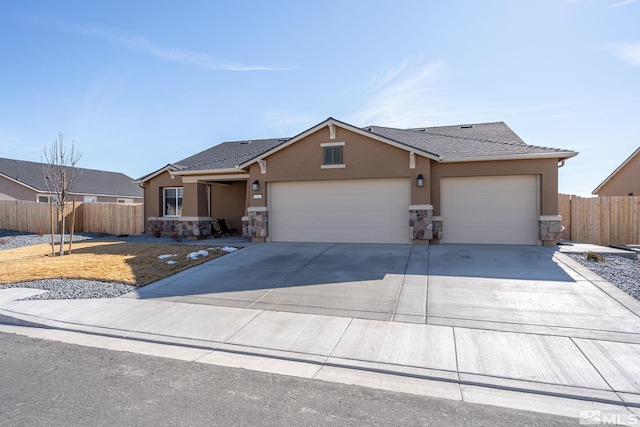 view of front of home with a garage, concrete driveway, fence, and stucco siding