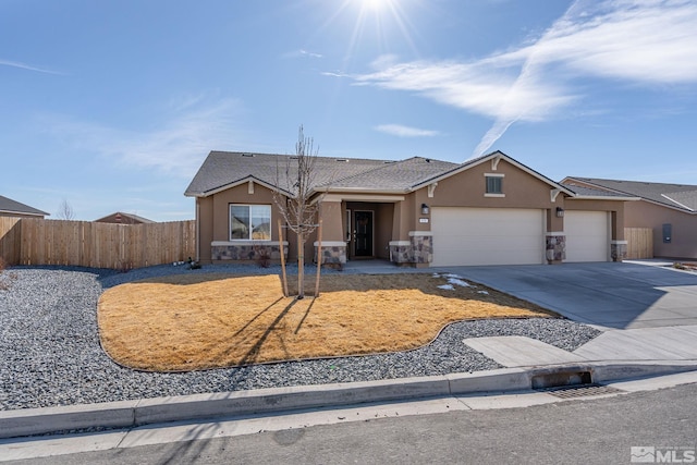 single story home with stucco siding, fence, a garage, stone siding, and driveway