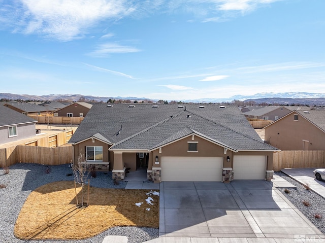 view of front of property with a garage, a residential view, fence, and stucco siding