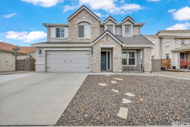 view of front of house featuring a garage, concrete driveway, fence, and stucco siding