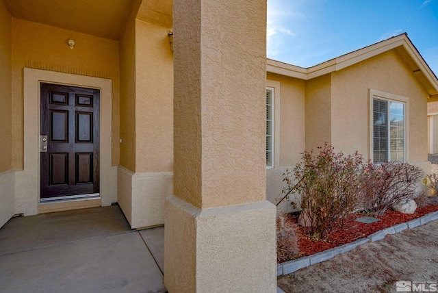 property entrance featuring stucco siding