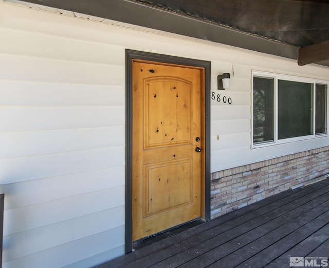 property entrance featuring brick siding