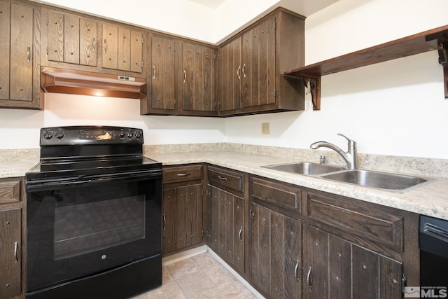 kitchen featuring black appliances, under cabinet range hood, and light countertops