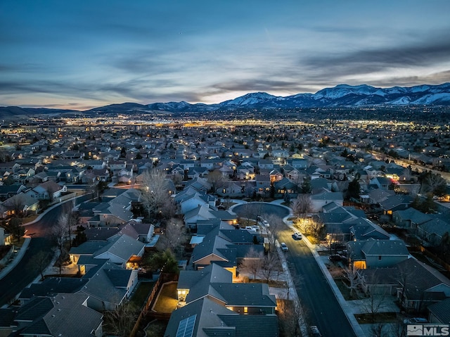 aerial view at dusk featuring a residential view and a mountain view