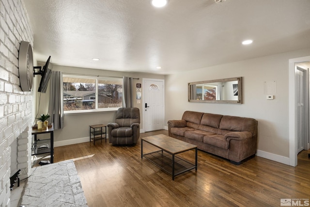 living room with dark wood-style floors, baseboards, and recessed lighting