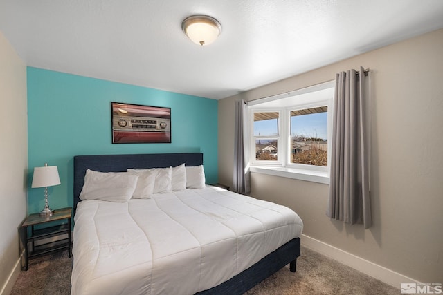 carpeted bedroom featuring baseboards