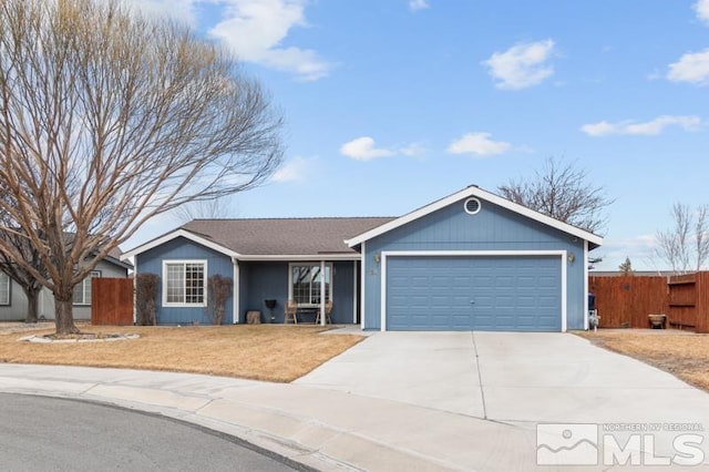 ranch-style house featuring a garage, driveway, and fence