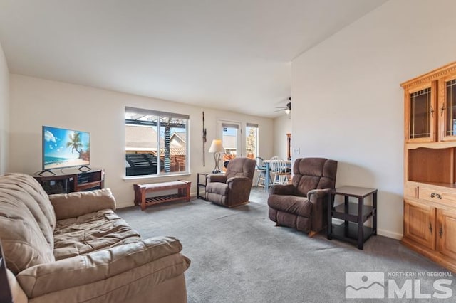 carpeted living area with baseboards