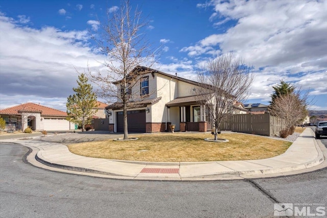 view of front facade with brick siding, stucco siding, fence, a garage, and driveway