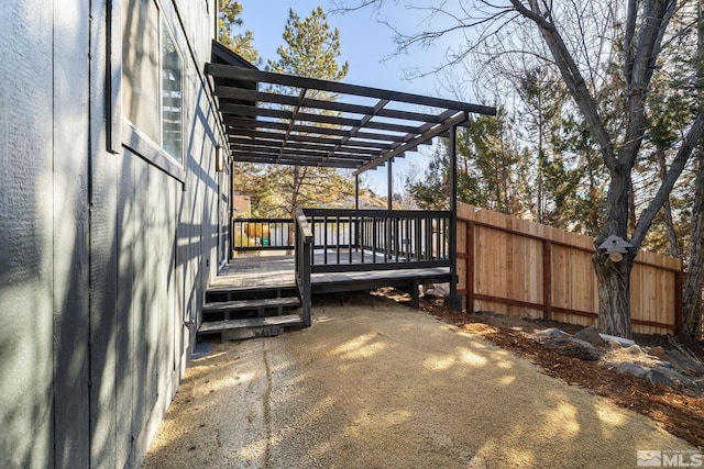 wooden deck featuring fence and a pergola