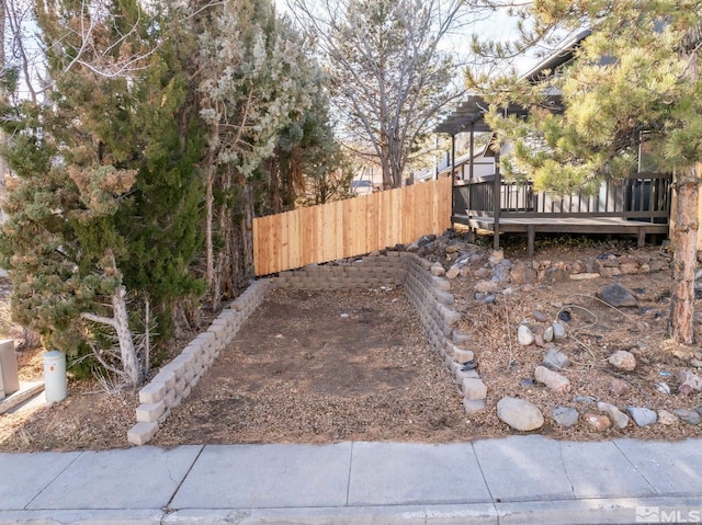 view of yard featuring fence and a deck