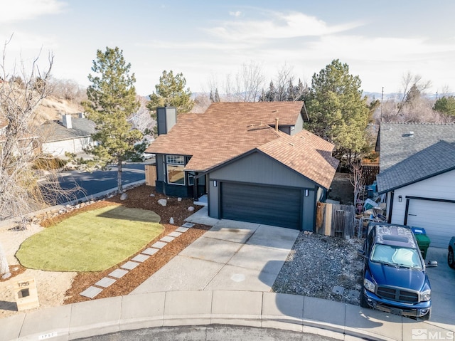 view of front of house featuring a chimney, a shingled roof, concrete driveway, an attached garage, and fence