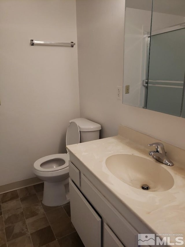 full bathroom with toilet and vanity