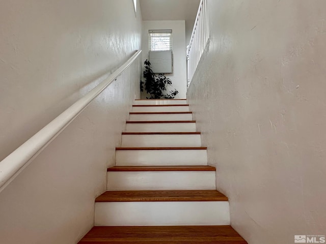 stairway featuring wood finished floors