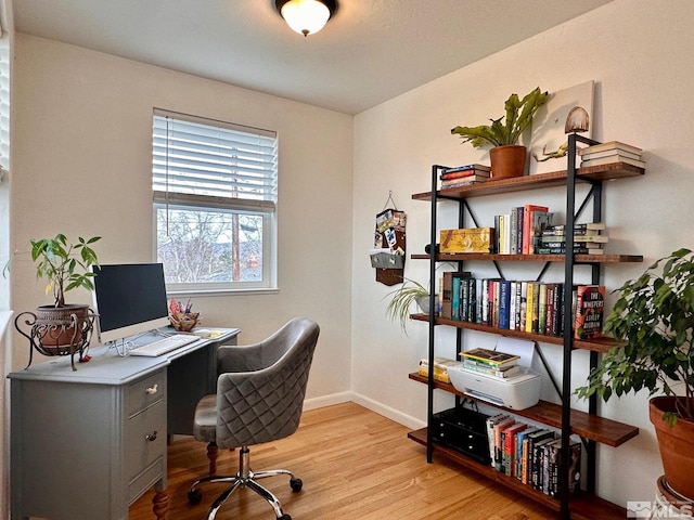 home office with light wood finished floors and baseboards