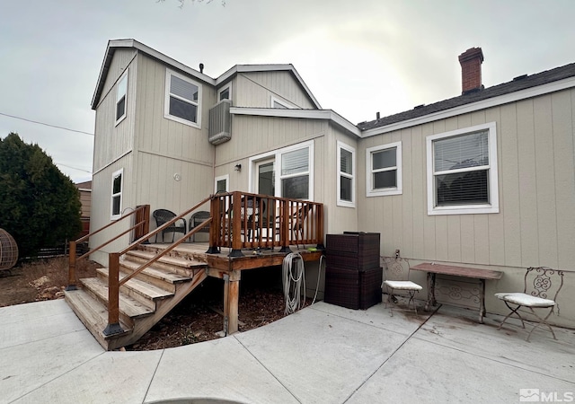 back of house with stairs, a deck, and a patio area