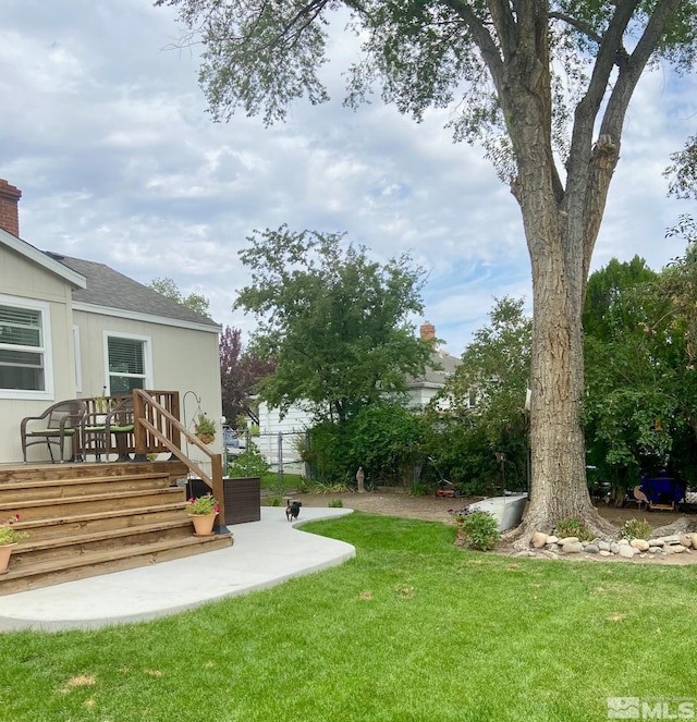 view of yard featuring fence and stairway