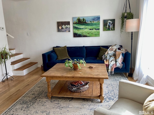 living room with wood finished floors and stairs