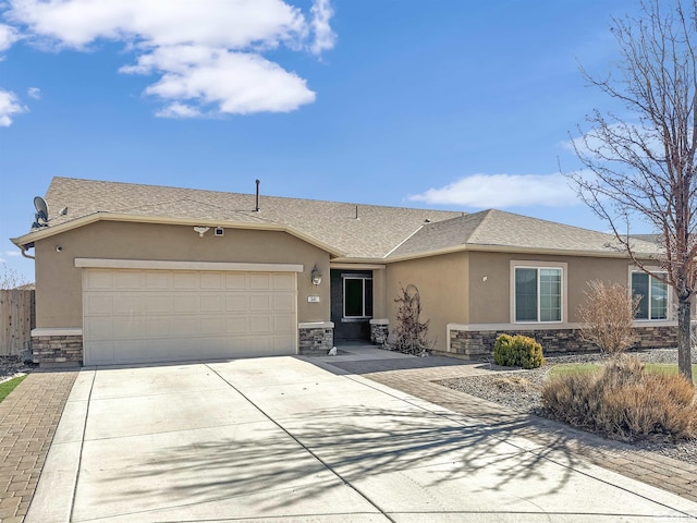 single story home with stone siding, an attached garage, and stucco siding