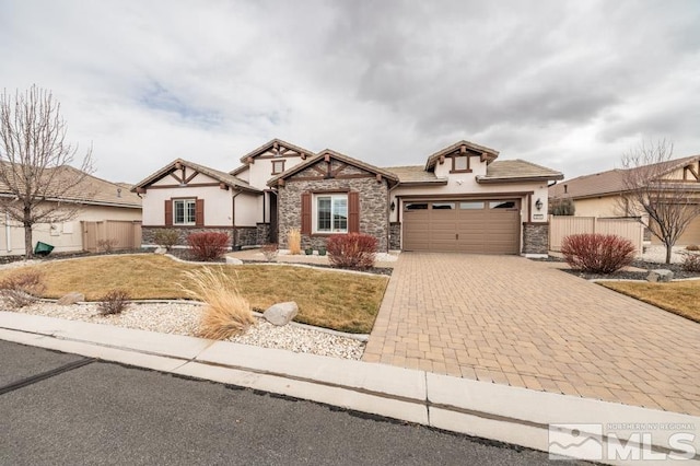 view of front of house with an attached garage, fence, decorative driveway, and stucco siding