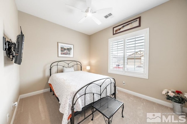 bedroom featuring baseboards, visible vents, a ceiling fan, and light colored carpet