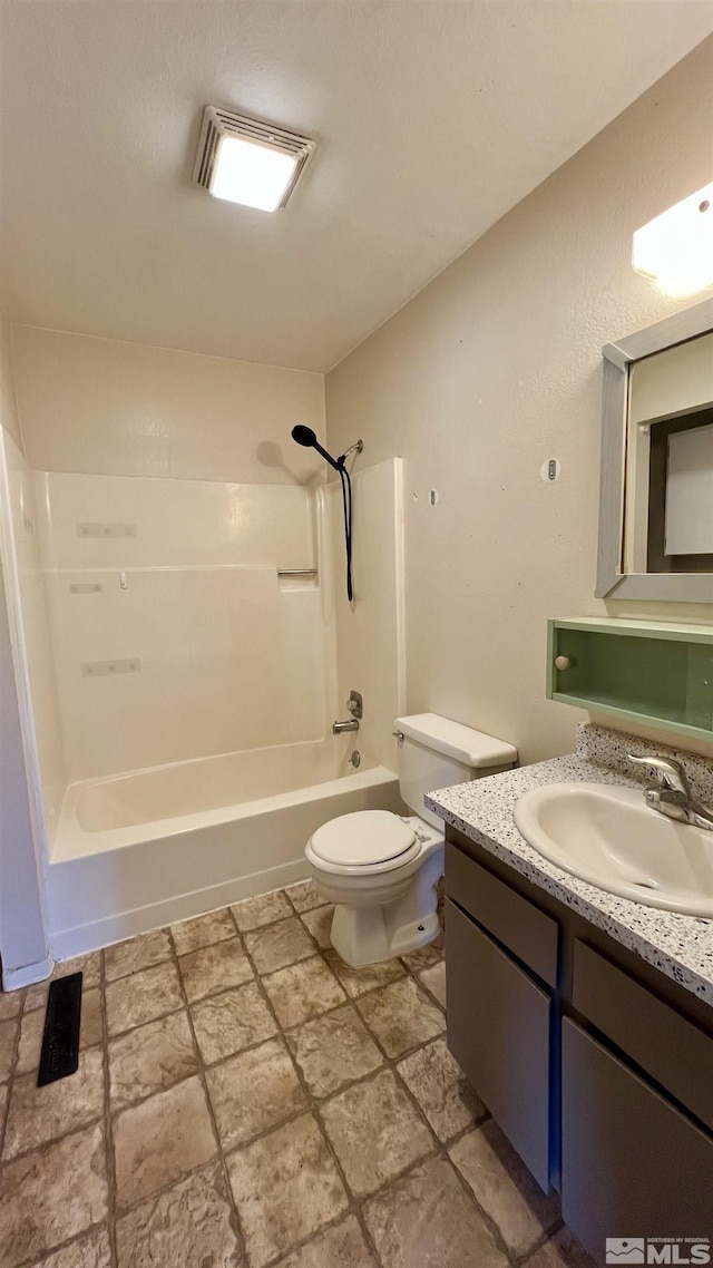 full bath featuring visible vents, toilet, stone finish flooring, vanity, and  shower combination