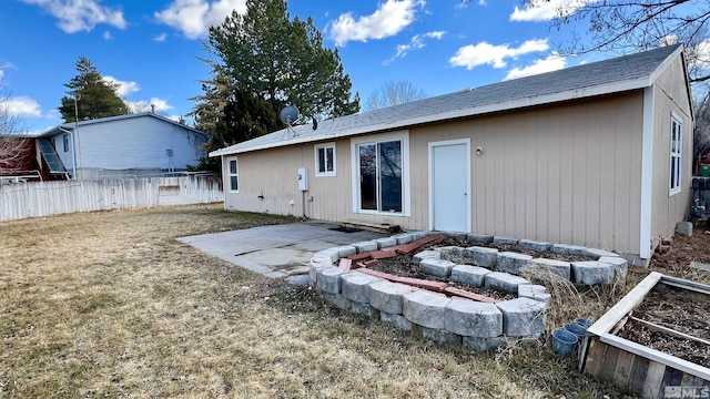 back of house with a patio, an outdoor fire pit, a lawn, and fence