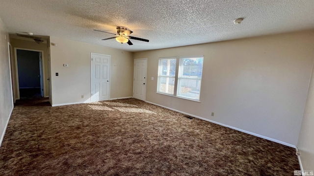 interior space with visible vents, baseboards, ceiling fan, carpet, and a textured ceiling