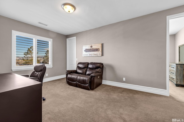 office space featuring baseboards, visible vents, and light colored carpet