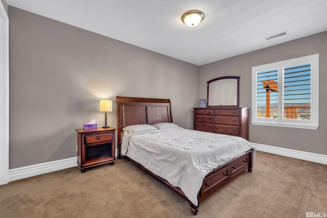 bedroom with light carpet, baseboards, and visible vents