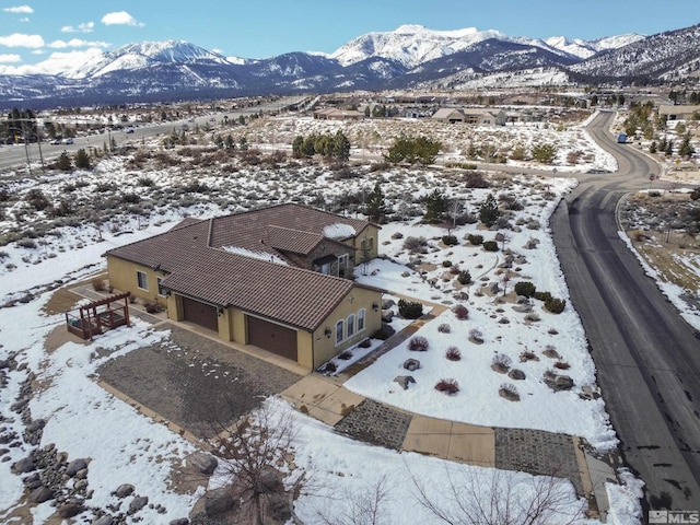 snowy aerial view with a mountain view