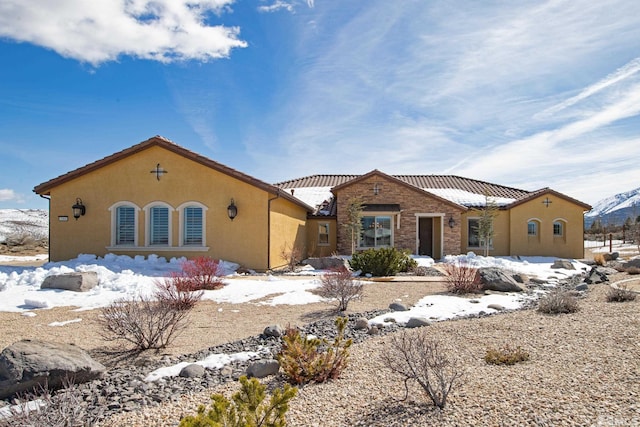 mediterranean / spanish-style home with a tile roof and stucco siding