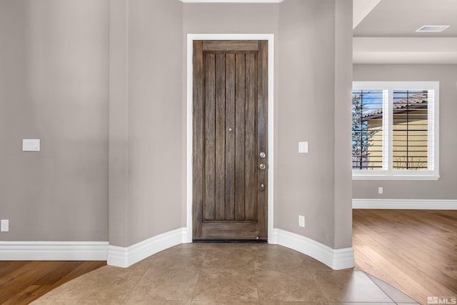 foyer with visible vents and baseboards