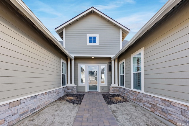 view of exterior entry featuring stone siding