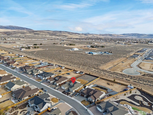 drone / aerial view featuring a residential view and a mountain view