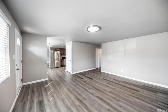 spare room with wood finished floors and baseboards