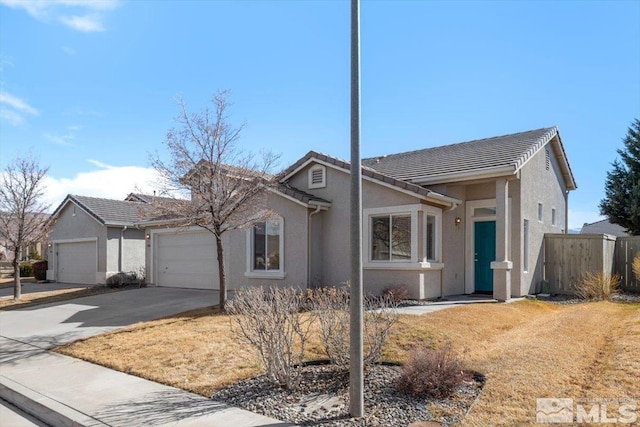 single story home featuring a garage, concrete driveway, fence, and stucco siding