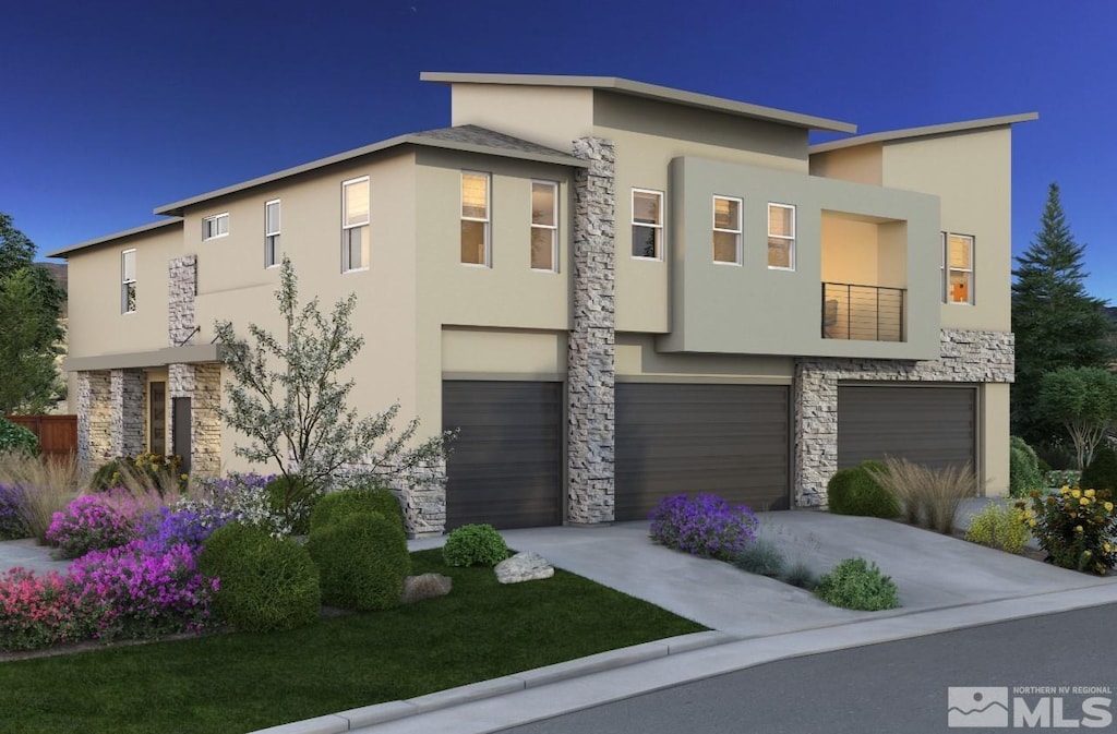 contemporary house featuring a garage, stone siding, concrete driveway, and stucco siding