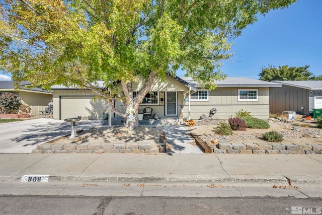 ranch-style house with driveway and an attached garage