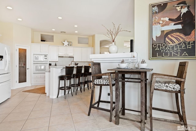 dining space featuring light tile patterned floors, visible vents, and recessed lighting