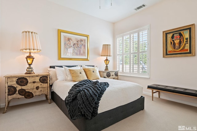 carpeted bedroom featuring visible vents