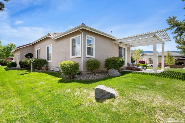 view of property exterior with stucco siding, a pergola, and a yard