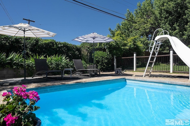 view of swimming pool featuring fence and a fenced in pool
