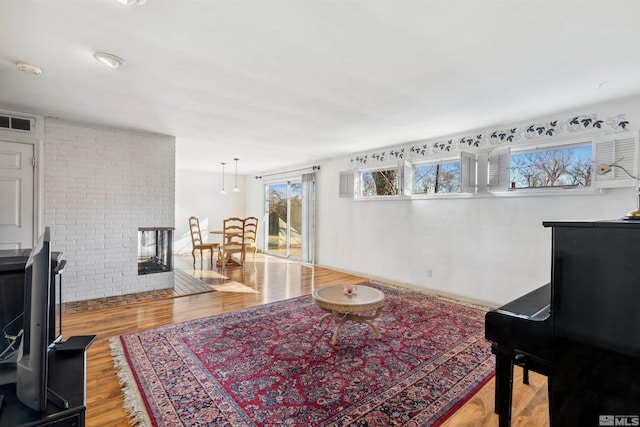 living room with light wood-type flooring and visible vents
