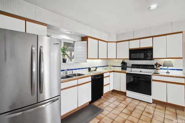 kitchen featuring black appliances, white cabinetry, light countertops, and a sink