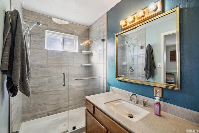 bathroom featuring a stall shower and vanity