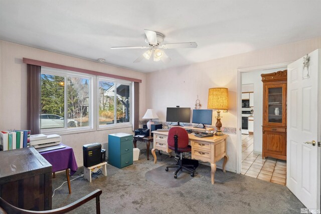 office area with light tile patterned flooring, ceiling fan, and light carpet