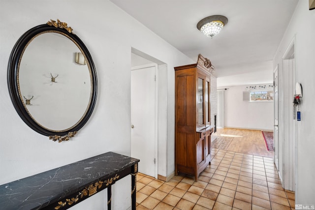 hall featuring light tile patterned floors